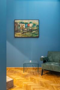 a living room with a couch and a painting on the wall at Iliotropio Athens, Thisio in Athens +117 photos