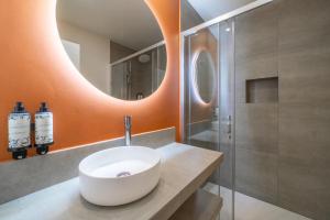 a bathroom with a white sink and a mirror at Castelo Guest House in Carvoeiro +80 photos