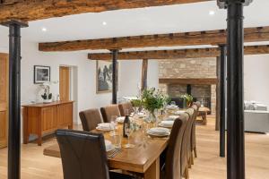 a dining room with a long table and chairs at Arlington Mill in Bibury