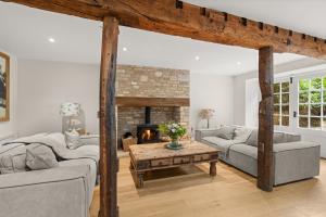 a living room with two couches and a fireplace at Arlington Mill in Bibury +22 photos