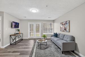 a living room with a couch and a table at Stylish 2BR2BA with room to unwind in Stockbridge