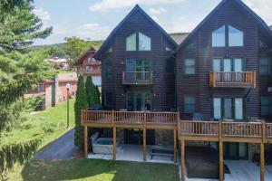 a large wooden house with a large deck at Cedar Shores Villa #06 by Railey Vacations in McHenry