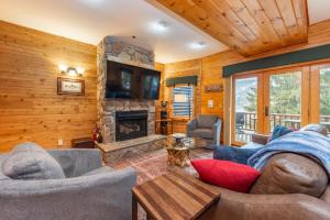 a living room with a couch and a fireplace at Cedar Shores Villa #06 by Railey Vacations in McHenry
