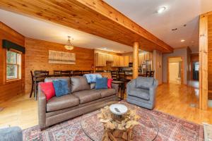 a living room with a couch and chairs and a kitchen at Cedar Shores Villa #06 by Railey Vacations in McHenry