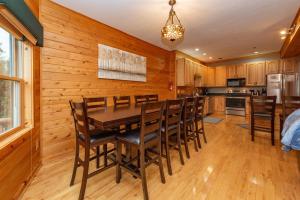 a kitchen with a dining room table and chairs at Cedar Shores Villa #06 by Railey Vacations in McHenry +33 photos