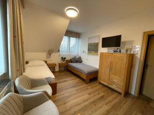 a small room with a bed and a couch at Hotel Wolfsjäger in Herbern