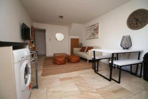 a kitchen and living room with a table and a living room at Rustic Retreat Opposite Stadium in Cardiff +11 photos