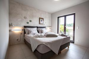 a bedroom with a large bed with two towels on it at Apartmani Vale in Hvar