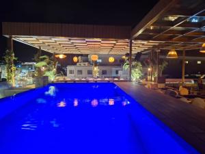 a swimming pool at night with blue illumination at Batroun boutique suites in Batroûn