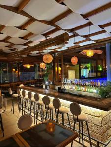 a bar at a restaurant with chairs and lights at Batroun boutique suites in Batroûn