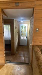 a small room with a bed and a door at Cabañas lugar de Refugio in Queilén