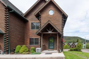 a wooden house with a green door at Cedar Shores Villa #19 by Railey Vacations in McHenry