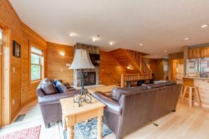 a living room with leather furniture and a fireplace at Cedar Shores Villa #19 by Railey Vacations in McHenry