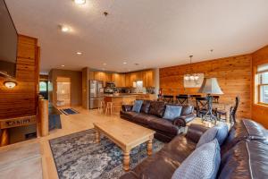 a living room with a couch and a table at Cedar Shores Villa #19 by Railey Vacations in McHenry