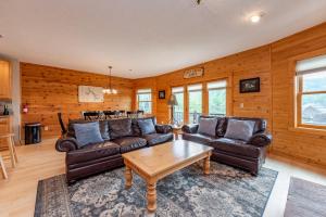 a living room with leather couches and a table at Cedar Shores Villa #19 by Railey Vacations in McHenry +92 photos