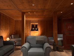 a living room with a couch and a chair at Hotel Gran Fanes in Corvara in Badia +87 photos