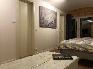 a bedroom with a bed and a book on a table at TrailHouse in Liptovský Mikuláš