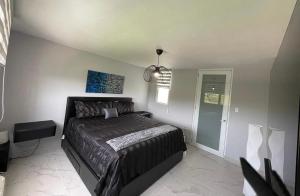 a bedroom with a bed with a black comforter at Luxury Apartment- 3 Bedrooms in Ceiba +5 photos