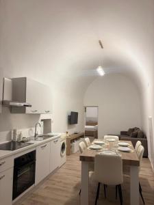 a kitchen and living room with a table and chairs at Vicolo Lungo Apartment in Nardò