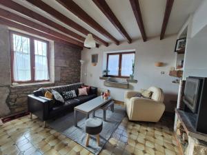 a living room with a couch and a table at Maison au calme en Chartreuse in Miribel-les-Échelles