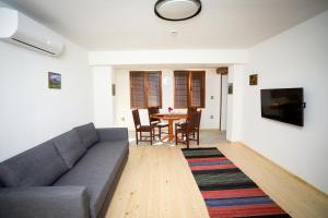 a living room with a couch and a table at Родопчани Старцево in Starzewo