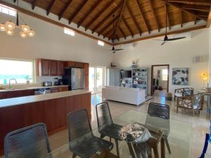 a kitchen and living room with a table and chairs at Lockrum Point Villa - Upscale Ocean Front, Pool with Gazebo in South Hill Village