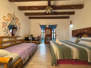 a bedroom with two beds and a ceiling at Nacional Beach Club & Bungalows in Mahahual