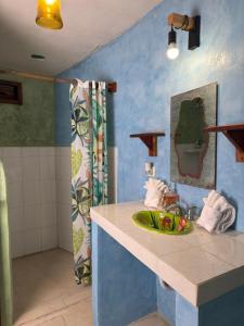 a bathroom with a sink and a mirror at Nacional Beach Club & Bungalows in Mahahual +69 photos
