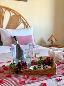 a table with a bottle of wine and two glasses at Aspra Mare House in Aspra