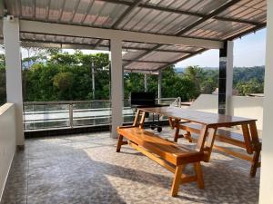 a patio with a wooden table and a bench at Sol de sauce - Casa Vacation Stay in Sauce