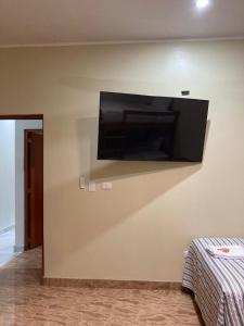 a flat screen tv hanging on a wall at Sol de sauce - Casa Vacation Stay in Sauce
