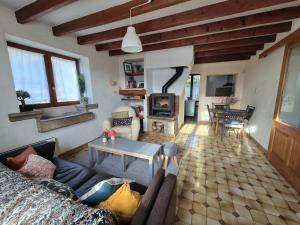 a living room with a couch and a table at Maison au calme en Chartreuse in Miribel-les-Échelles