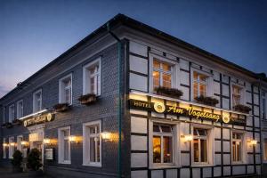 a hotel with a sign on the side of a building at Hotel Am Vogelsang in Gevelsberg