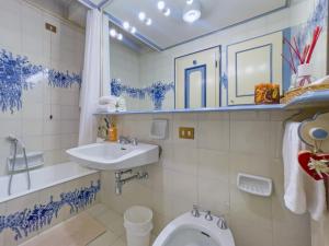 a bathroom with a toilet and a sink at I cuori in Cortina dʼAmpezzo +6 photos