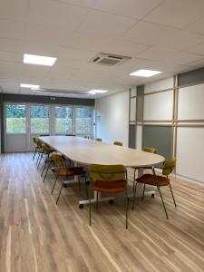 a large conference room with a large table and chairs at Green Hôtels Poitiers in Poitiers