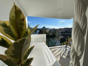 a room with a plant on a balcony with a view at La Madriguera in Guatapé +131 photos
