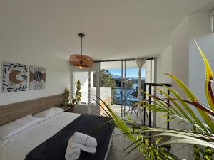 a bedroom with a bed and a large window at La Madriguera in Guatapé