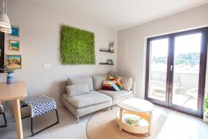 a living room with a couch and a table at Apartmani Vale in Hvar