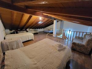 a room with two beds and a chair in a room at Casa Martins by Tear in Aldeia de João Pires