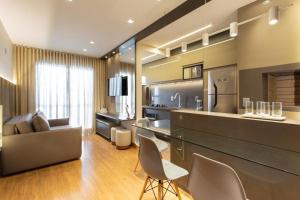 a kitchen and living room with a counter and chairs at AP1011 Gray Eleven in Santa Maria