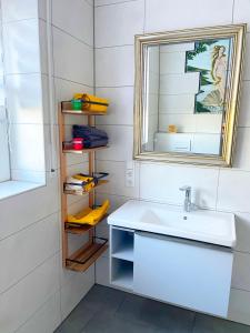 a bathroom with a sink and a mirror at Beimannskath in Kalkar +28 photos
