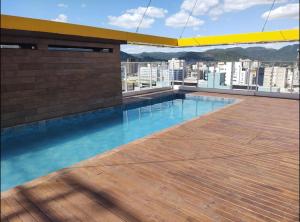 a swimming pool on the roof of a building at AP1011 Gray Eleven in Santa Maria