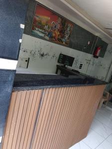 an office with a counter with a painting on the wall at Braj Darshan Bhawan in Jāmb