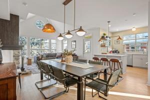 a kitchen and dining room with a table and chairs at Tremblant Prestige - Les Eaux 221-3 in Mont-Tremblant