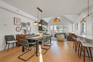 a kitchen and living room with a table and chairs at Tremblant Prestige - Les Eaux 221-3 in Mont-Tremblant