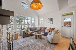 a living room with a couch and a table at Tremblant Prestige - Les Eaux 221-3 in Mont-Tremblant