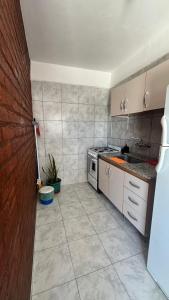 a kitchen with a sink and a stove at Maximina Home in Comodoro Rivadavia