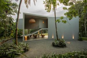 a house in the middle of a forest with palm trees at The Sevana in Talalla South