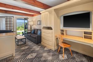 a living room with a television and a couch at von Trapp Family Lodge & Resort in Stowe