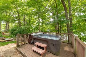 a hot tub on a wooden deck with a stool at Corks Away by Railey Vacations in McHenry +42 photos